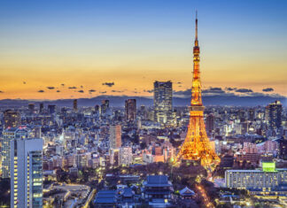 Tokyo Japan cityscape with illuminated tower at sunset sky background