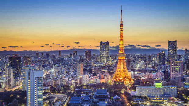 Tokyo Japan cityscape with illuminated tower at sunset sky background