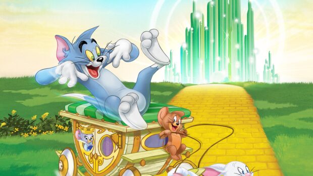 Tom and Jerry characters enjoying a whimsical scene with a yellow brick road and emerald city in the background