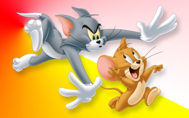 Tom and Jerry cartoon characters chasing each other in a colorful scene