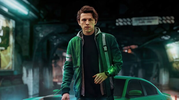 Tom Holland standing confidently in a green jacket near a car in an urban setting