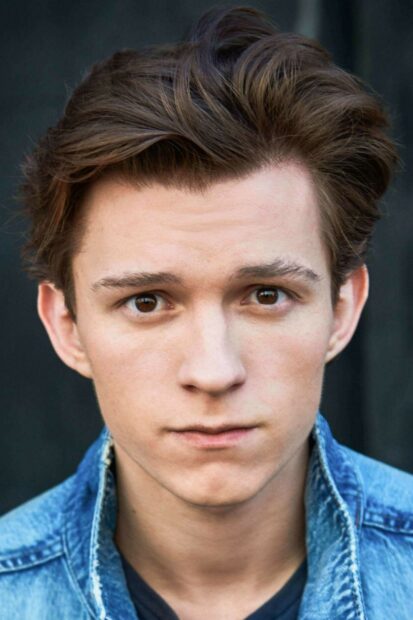 Young actor Tom Holland looks serious with brown eyes in a close up portrait