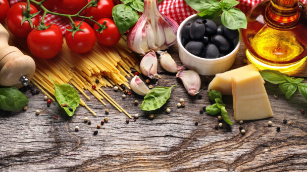 Fresh tomato with garlic and olives on rustic wooden table