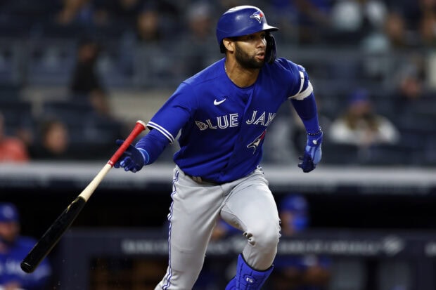 Toronto Blue Jays player in action swinging a bat during the game in blue uniform