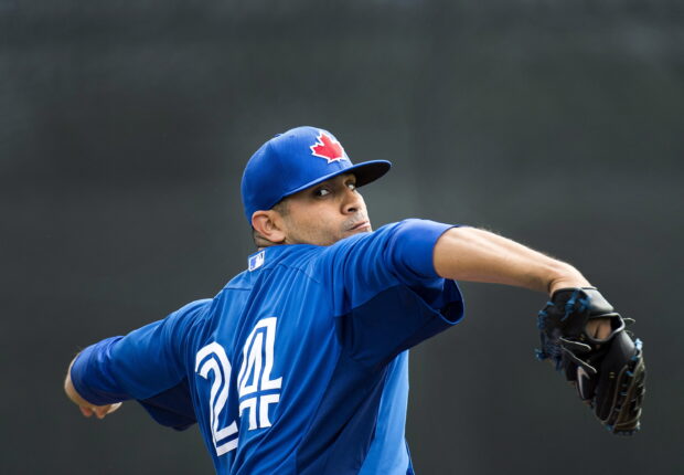 A Toronto Blue Jays player wearing number 24 prepares to pitch during a game