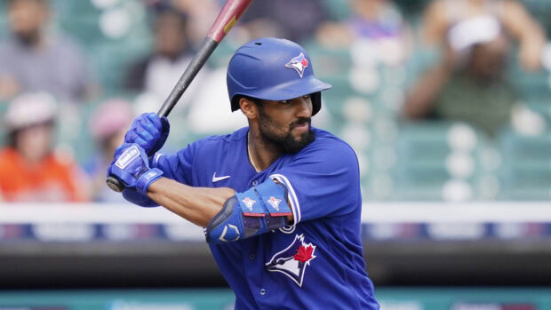 A Toronto Blue Jays player in blue uniform preparing to bat during a baseball game