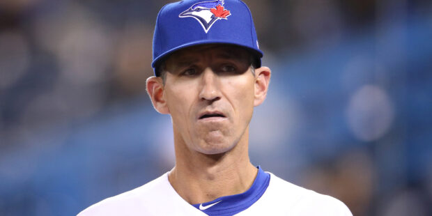 A Toronto Blue Jays player wearing a blue cap with the team's logo on the field