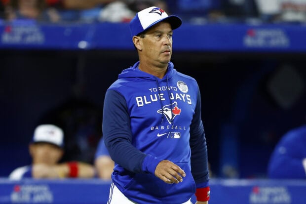A man wearing Toronto Blue Jays apparel on the baseball field during a game