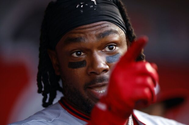 Close up of Toronto Blue Jays player with eye black and red glove pointing