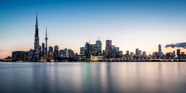 A stunning view of the Toronto skyline at dusk featuring famous buildings and waterfront reflections