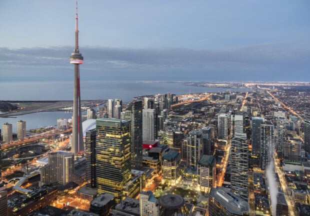 Toronto skyline with CN Tower and city lights at dusk showing urban architecture