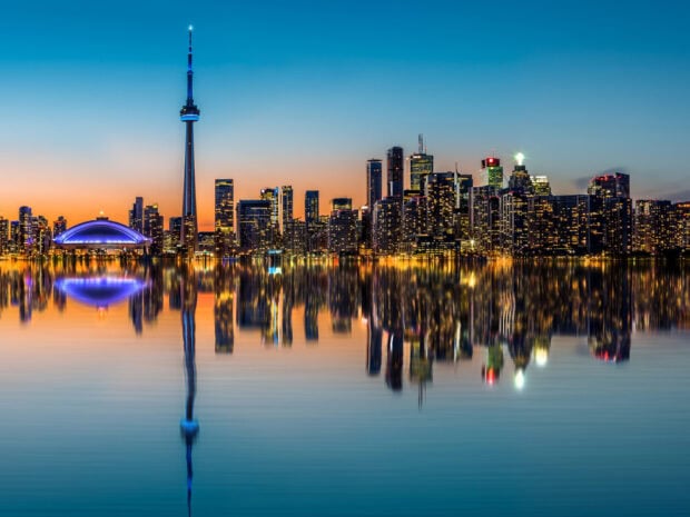Toronto skyline cityscape at dusk with clear reflections in the water