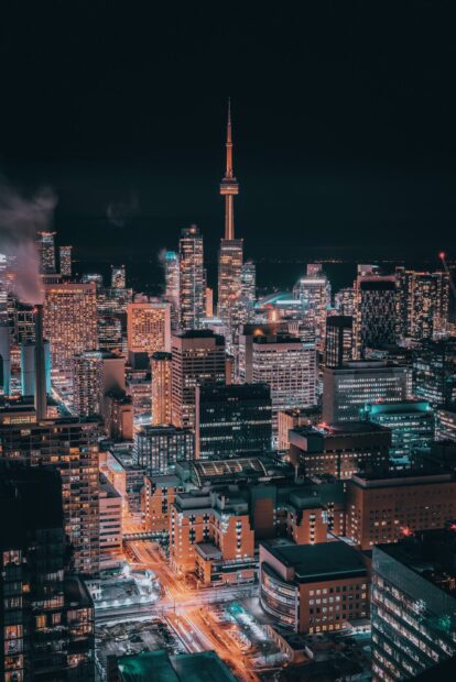 Night view of Toronto skyline with illuminated buildings and CN Tower in high definition