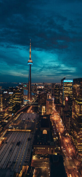 Toronto skyline illuminated at night with towering buildings and city lights