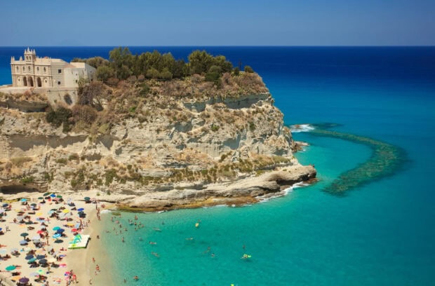 Tropea coast cliff and beach with turquoise water in summer