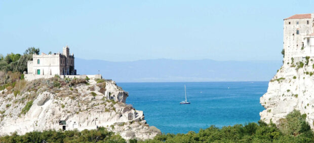 Ancient buildings on cliffs overlooking the blue sea in Tropea