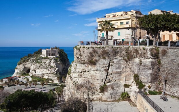 Ancient castle on cliff surrounded by Mediterranean sea in Tropea town