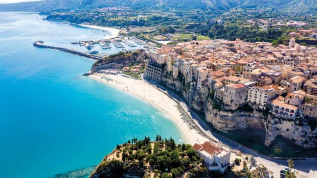 A stunning aerial view of Tropea coastline with cliffs and turquoise sea in clear weather