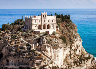 Historic building on rocky cliff in Tropea surrounded by Mediterranean Sea