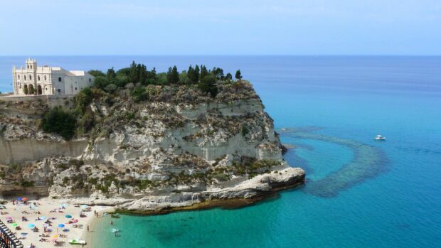 Tropea coastline with clear blue water and historic cliffside architecture