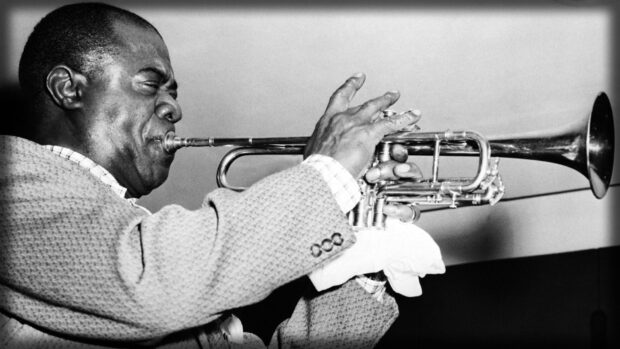 A musician passionately playing a trumpet in a black and white image
