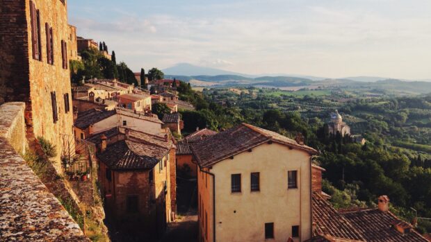 Old rustic buildings and green hills typical of Tuscany landscape in Italy