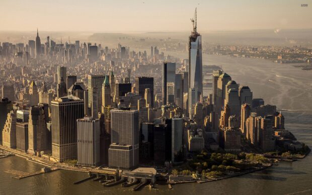 Aerial view of usa skyline with prominent skyscrapers along the waterfront in golden sunlight