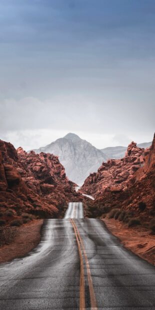 A winding road through rocky red mountains in the usa landscape