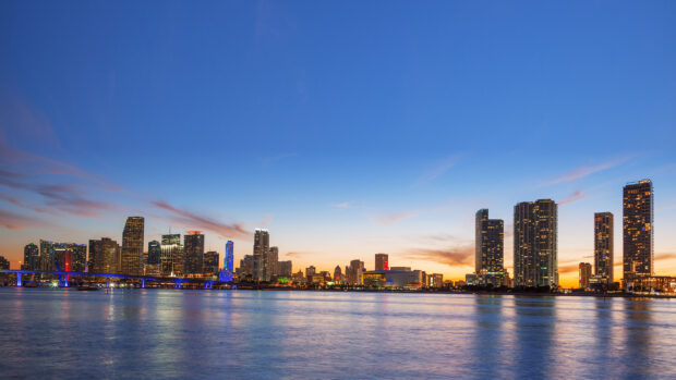 Beautiful Usa cityscape with clear sky reflecting on water at sunset