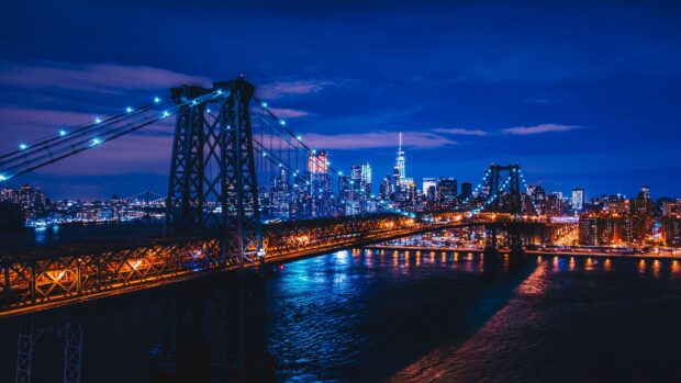 Nighttime cityscape with usa bridge and skyline illuminated in blue and orange lights