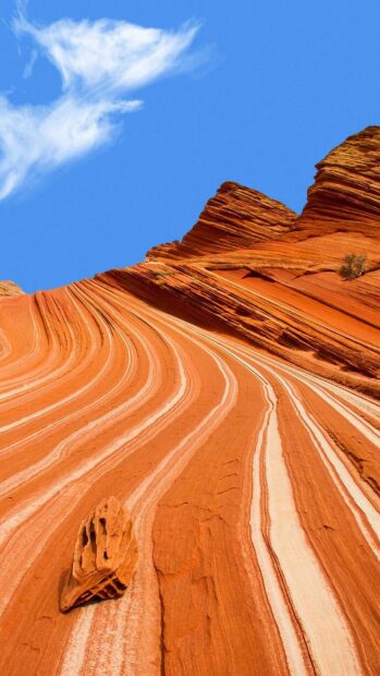 Unique Utah rock formations with layered sandstone under a blue sky