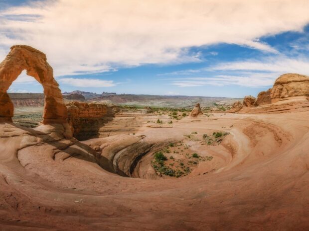 Natural rock formation in Utah desert landscape with clear blue sky