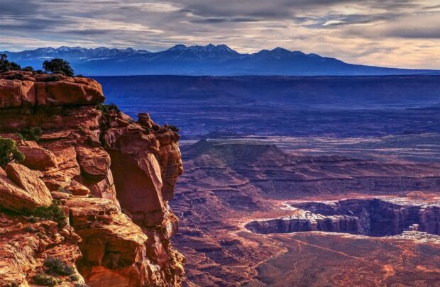 Red rock formations and vast desert landscape in Utah canyon