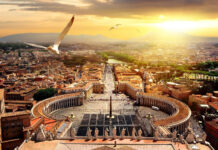 A bird flying over Vatican City in the golden sunlight with panoramic view