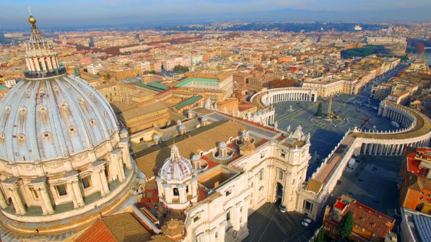 The aerial view of Vatican City showing iconic domes and the large Saint Peter's Square with the obelisk