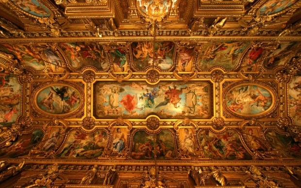 Ornate Vatican City ceiling with classical paintings and golden decorations in a historic palace