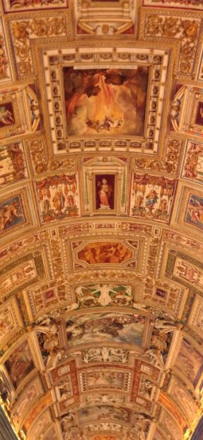Intricate Vatican City ceiling adorned with classical frescoes and sculptures