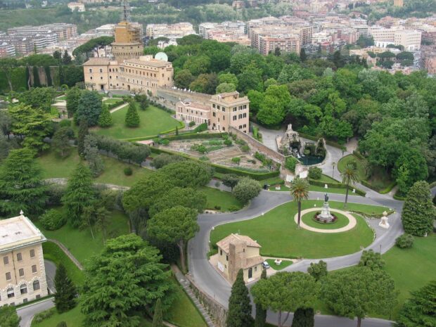 Aerial view of Vatican City gardens showcasing lush greenery and historical buildings