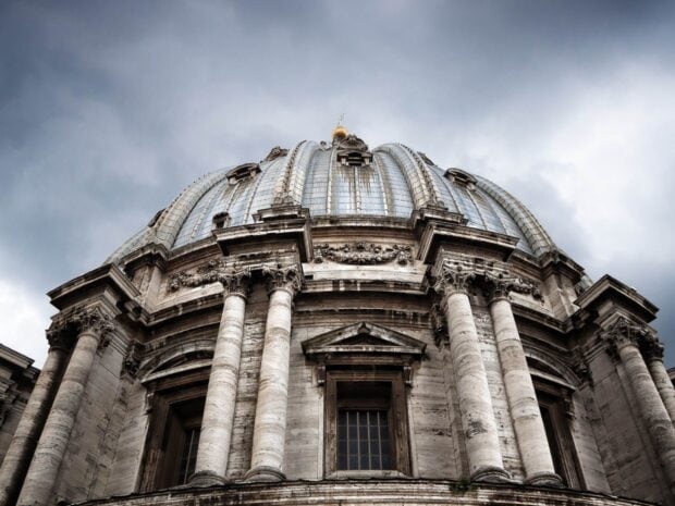 A close up view of Vatican City dome showcasing ancient architecture and classic columns