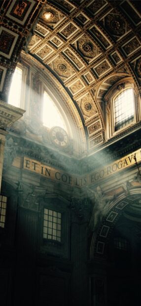Interior details of Vatican City with ornate ceiling and light rays through windows
