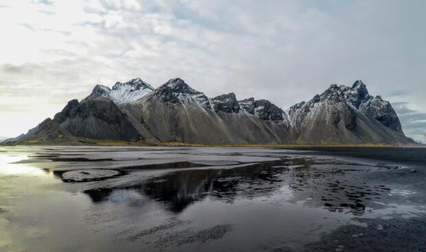 Dramatic Vestrahorn Iceland mountain landscape reflected in calm water