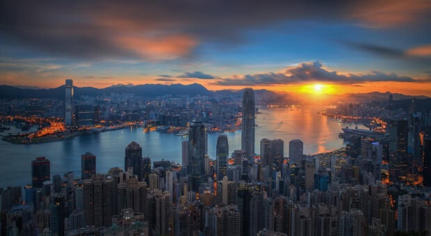 Victoria Peak cityscape seen at sunset with vibrant sky and glowing lights