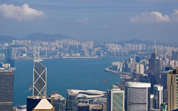 A panoramic view of Victoria Peak showcasing the urban skyline and harbor in high resolution