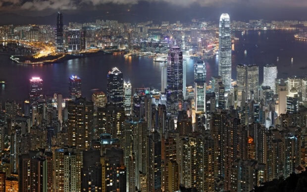 Nighttime city skyline with Victoria Peak buildings illuminated at night