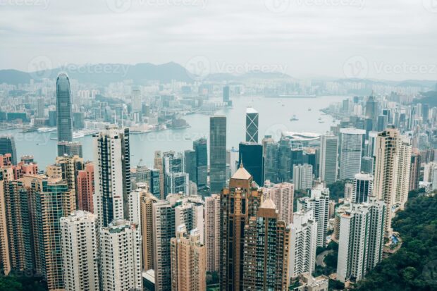 City skyline with Victoria Peak and skyscrapers on a cloudy day