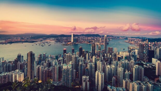 Vibrant cityscape of Victoria Peak at sunset with clear sky and urban skyline