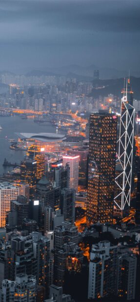 Evening cityscape at Victoria Peak with illuminated buildings and harbor lights
