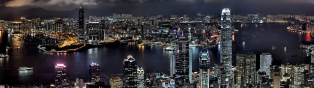 Nighttime cityscape of Victoria Peak buildings and harbor lights in Hong Kong