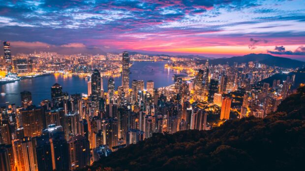 Stunning cityscape view of Victoria Peak with vibrant evening lights and colorful sky