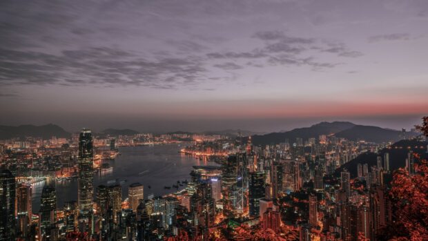 Night cityscape view from Victoria Peak with glowing buildings and landscape